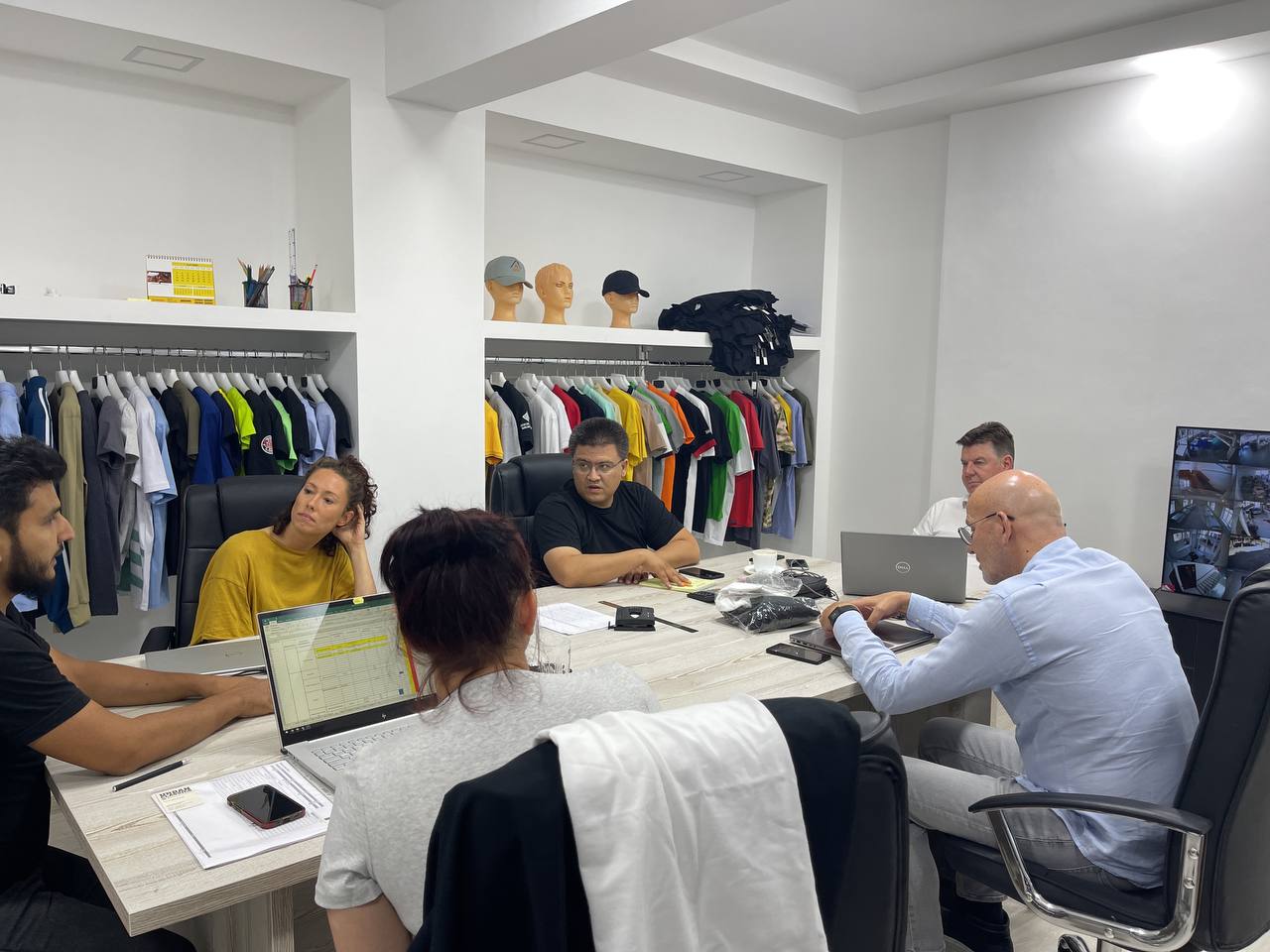 SAAS Teks Invest team reviewing a garment production order